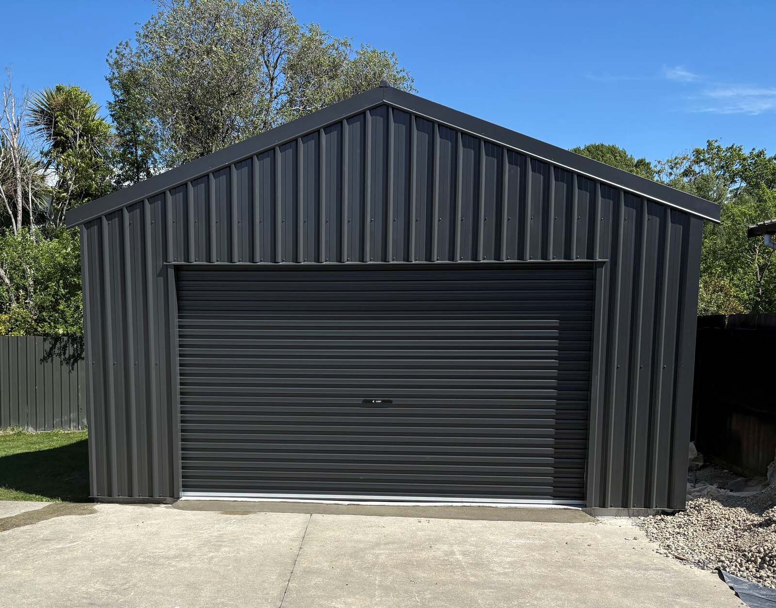A finished charcoal Colorsteel kitset garage on a Waikato section